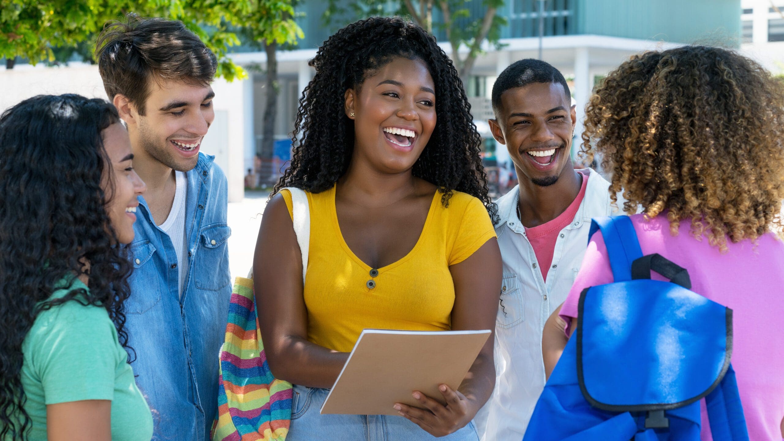 Group of laughing Latin American and caucasian male and female students