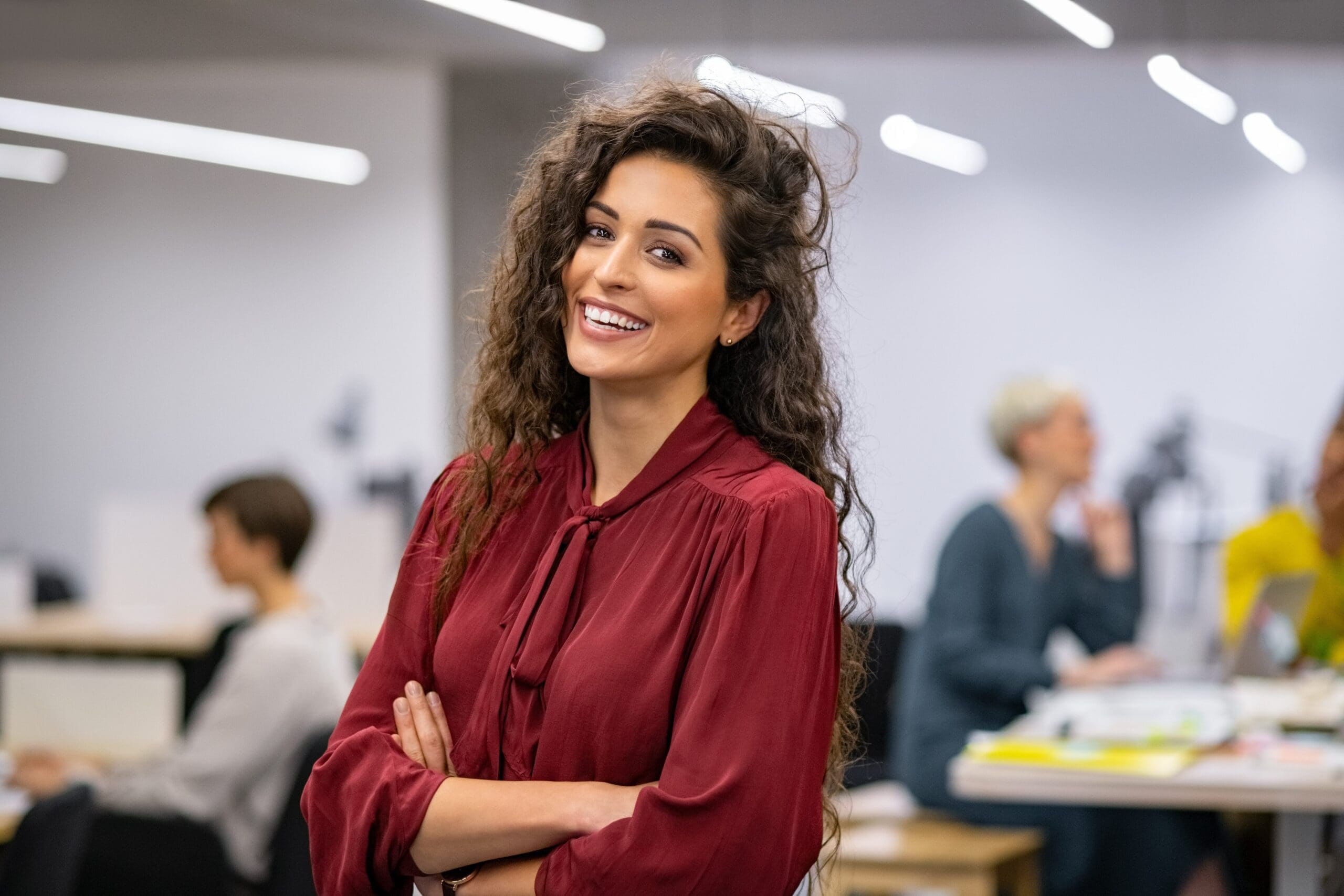 Successful Hispanic businesswoman standing in creative