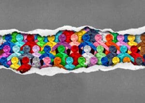 Discovering Diverse Culture and social justice inclusion as a group of people from different cultures under torn paper as a symbol for a united society or workplace unity