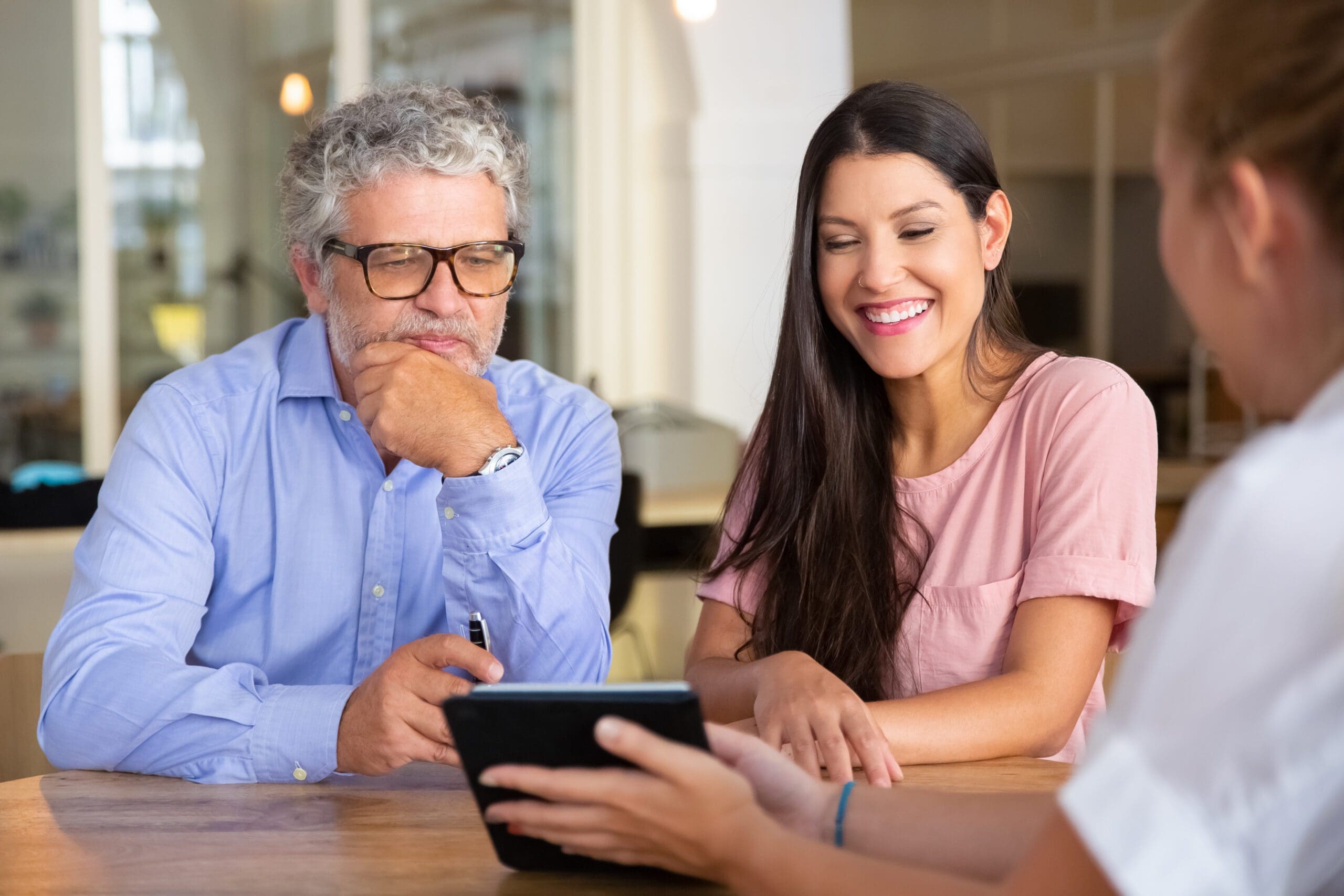 Happy young woman and mature man meeting with professional